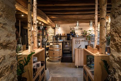 a large room with a bar and a wine cellar at Le Domaine des Prés Verts Suites & Chambres avec Jacuzzi Privatif in Jouey