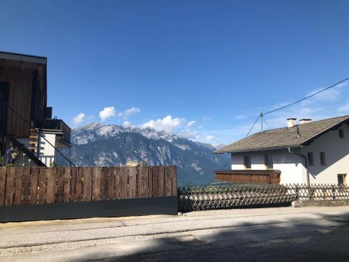 a house and a fence with mountains in the background at Vergiss mein nicht in Grinzens