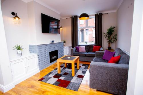 a living room with two couches and a fireplace at First house in Kettering