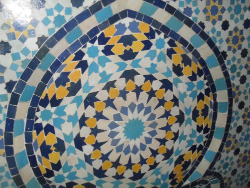 a close up of a tile pattern on a wall at Dar Lbakal in Chefchaouene