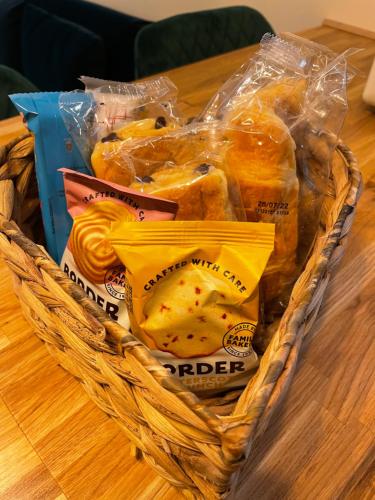 a basket filled with pastries on a table at The Cabin, Stronua. A beautiful 1 bedroom cabin. in Fort Augustus