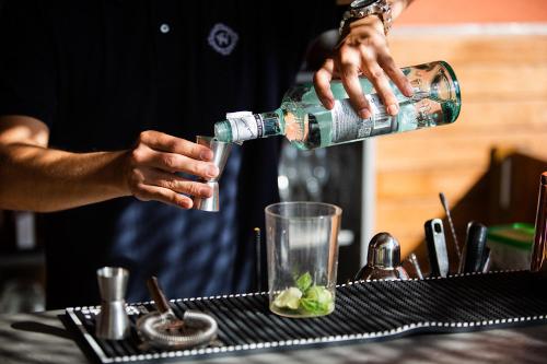 a man pouring a bottle of water into a glass at Hotel Well and Come Barcelona in Barcelona