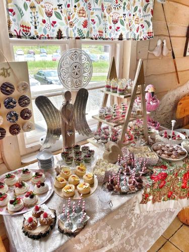 a table with many different types of desserts and pastries at Karczma Kubalonka in Istebna