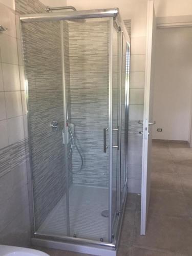 a shower with a glass door in a bathroom at Appartamento dei nonni di Gio e Cry in Sperlonga