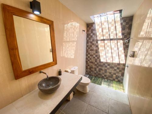a bathroom with a sink and a shower at Pattri Garden Lembongan in Nusa Lembongan