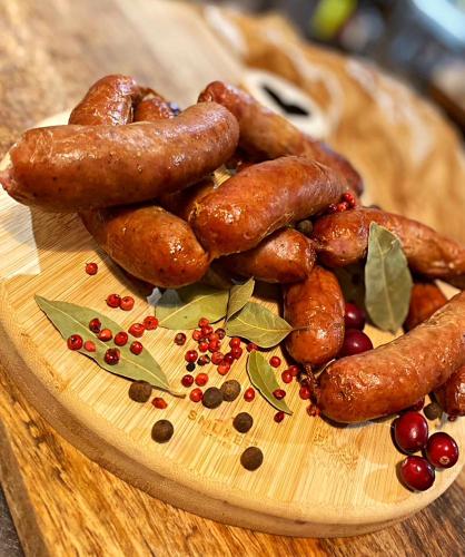 a plate of sausages and other food on a table at Karczma Kubalonka in Istebna