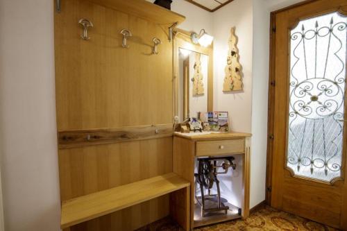 a bathroom with a sink and a mirror and a window at Il Marangon in Prato Carnico