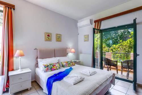a bedroom with a bed and a balcony at Villa Margarita Exi by Villa Plus in Kalyves