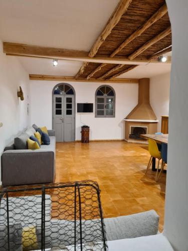 a living room with a couch and a fireplace at Villa Al Kharoube in Essaouira