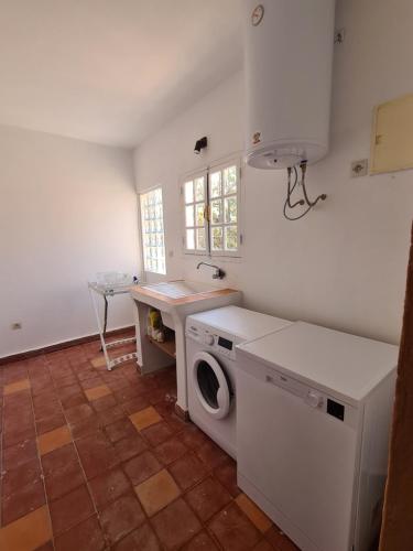 a kitchen with a washing machine and a sink at Villa Al Kharoube in Essaouira