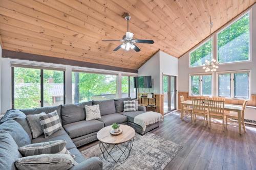a living room with a couch and a table at Village of Loon Condo in Lincoln with Pool Access in Lincoln