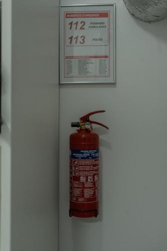 a fire extinguisher is hanging on a wall at Les Pantoufles dans le Pré in Eppeldorf