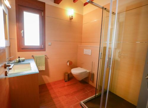 a bathroom with a toilet and a sink and a shower at Casa Paquita in Calpe