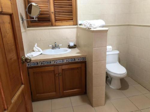 a bathroom with a sink and a toilet at Parque Natural Ixpanpajul in Santa Elena