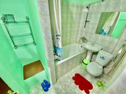 a small bathroom with a toilet and a sink at Hostel Loco in Almaty