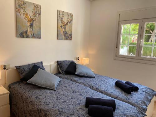 a bedroom with a bed with two pillows on it at Villa Excelente, with a private pool in Murcia