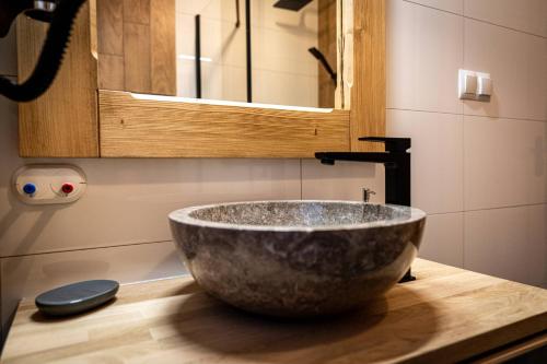 a bathroom with a large bowl sink on a counter at Dworek nad Jałowcami z Jacuzzi in Biały Dunajec