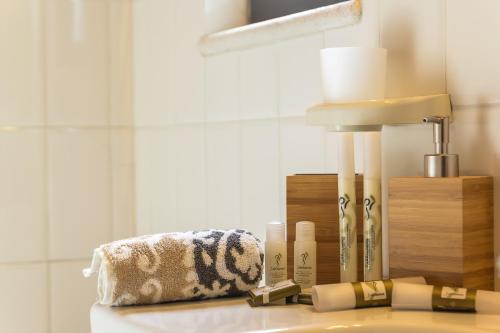 a bathroom counter with a towel and a lamp at Casa Urbano in Taormina