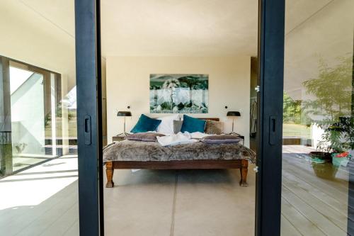 Säng eller sängar i ett rum på Vakantiewoning Leie Lodge