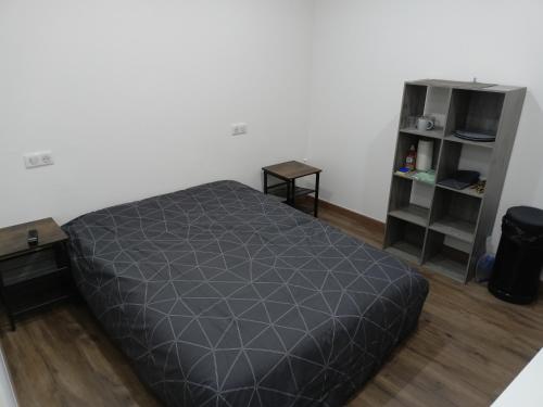 a bedroom with a bed and a book shelf at Chambre indépendante en plein centre Ville in Roye