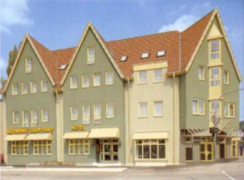 ein großes grünes Gebäude mit rotem Dach in der Unterkunft Hotel Zeller Zehnt in Esslingen