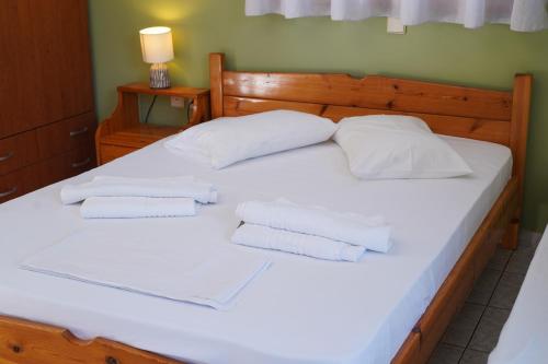 a bed with two white pillows on top of it at Beach Side Apartments in Dhrepanon
