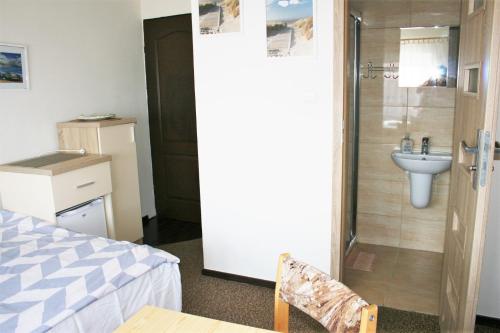 a bathroom with a shower with a sink and a toilet at Arnina in Władysławowo