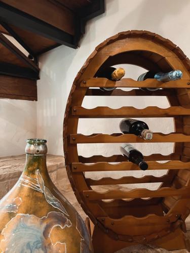 a wooden wine rack with a bottle of wine at Suite San Pietro in Galatina