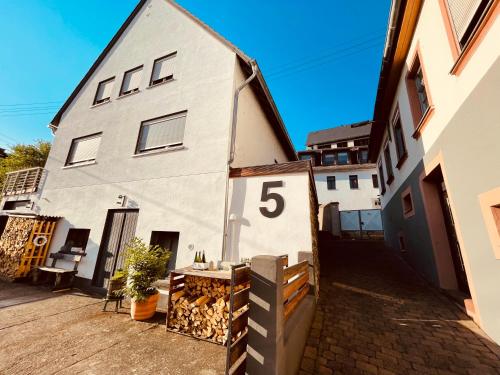 a white house with the number on it at Gästehaus Klostergasse in Lorch am Rhein