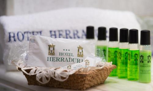 a basket with four bottles of hair products on a counter at Hotel Herradura in Santiago de Compostela