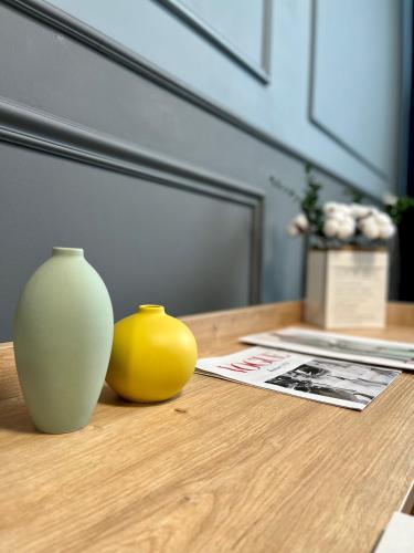 two vases sitting on top of a wooden table at Express Inn in Poti