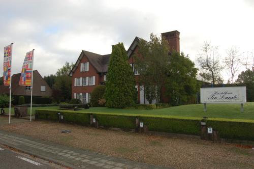 a house with a sign in front of it at Hotel Ten Lande in Beernem