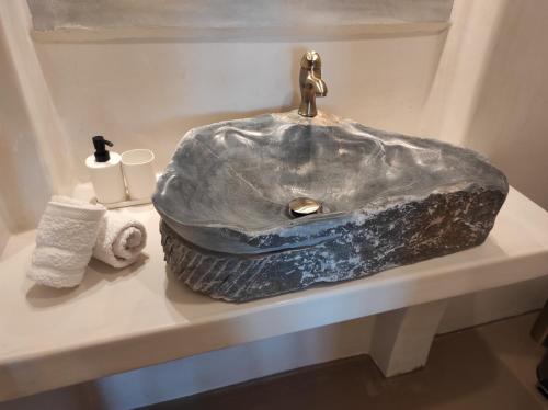 a bathroom with a sink with a marble sink at Traditional suites in Chora Kythnos #6 in Kithnos