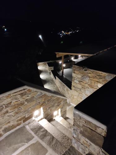 a stone staircase at night with a bench and lights at Traditional suites in Chora Kythnos #6 in Kithnos