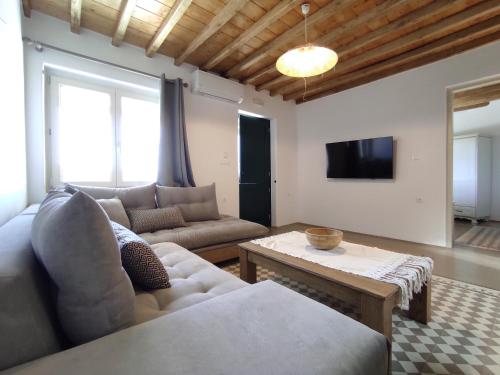 a living room with a couch and a table at Traditional suites in Chora Kythnos #6 in Kithnos