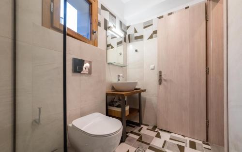 a bathroom with a toilet and a sink at IONIS Apartments in Preveza