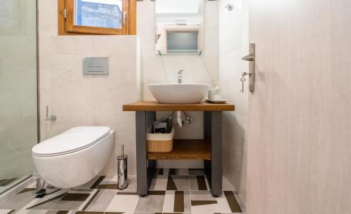 a bathroom with a sink and a toilet at IONIS Apartments in Preveza