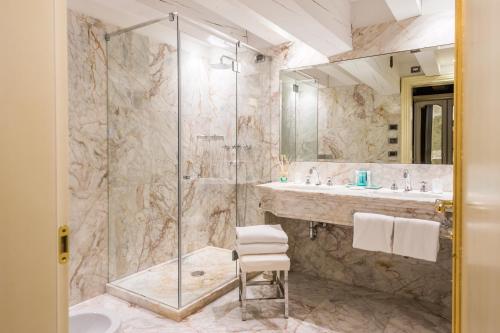 a bathroom with a shower and a sink at Hotel Ai Reali - Small Luxury Hotels of the World in Venice