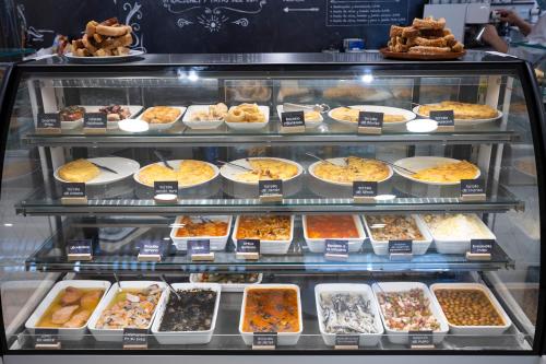 a display case filled with lots of different types of food at Hotel Restaurante Cadosa in Soria