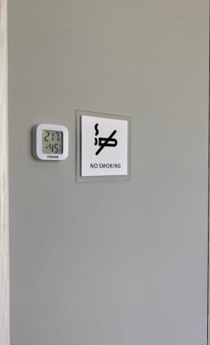 a sign on a door with a no smoking sign at Express Inn in Poti