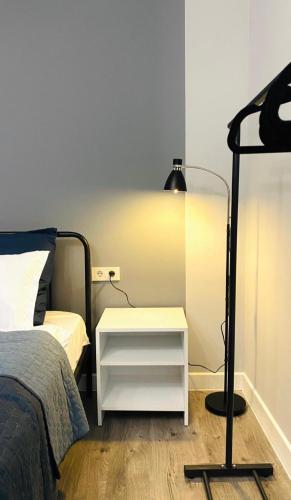 a bedroom with a bed and a white night stand at Express Inn in Poti