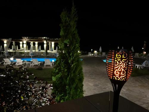 a sign in front of a pool at night at Family Hotel Eterno in Tsigov Chark