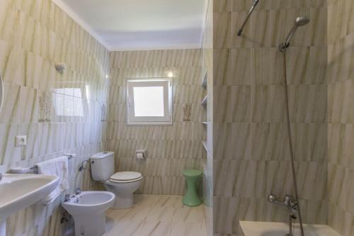 a bathroom with a shower and a toilet and a sink at Beach House Alcanada in Alcudia