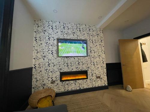 a living room with a wall with a tv on it at Roe Valley Apartments in Limavady