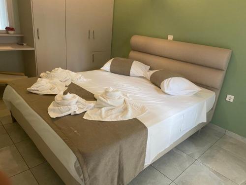 a bed with towels on it in a room at Marko's Cozy Apartment in Megalochori