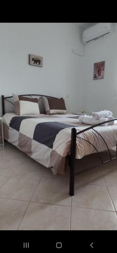 a large bed sitting in a room with at Panos Luxury Suites in Kalabaka