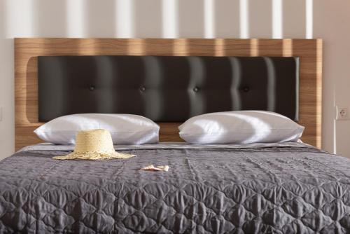 a hat sitting on top of a bed with pillows at Marianna Studios in Kriaritsi