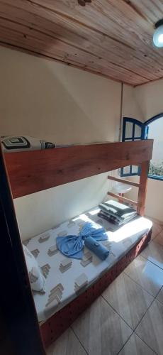 a bunk bed in a room with a wooden ceiling at Pousada Querência in Alto Caparao