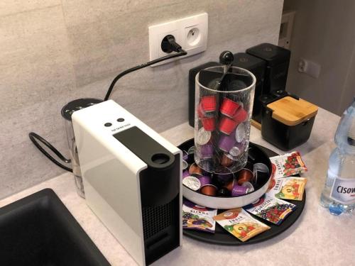 a counter with a blender and a bowl of candy at Wiślane Tarasy 2.0, free parking, private garden in Kraków