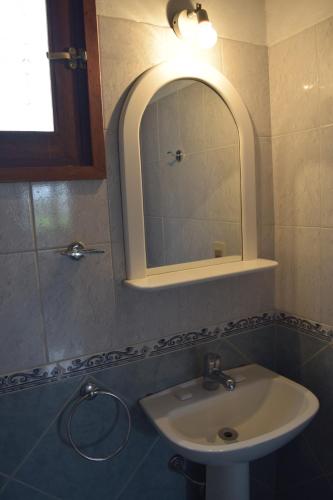 a bathroom with a sink and a mirror at Bungalows Costa Esmeralda in La Paloma